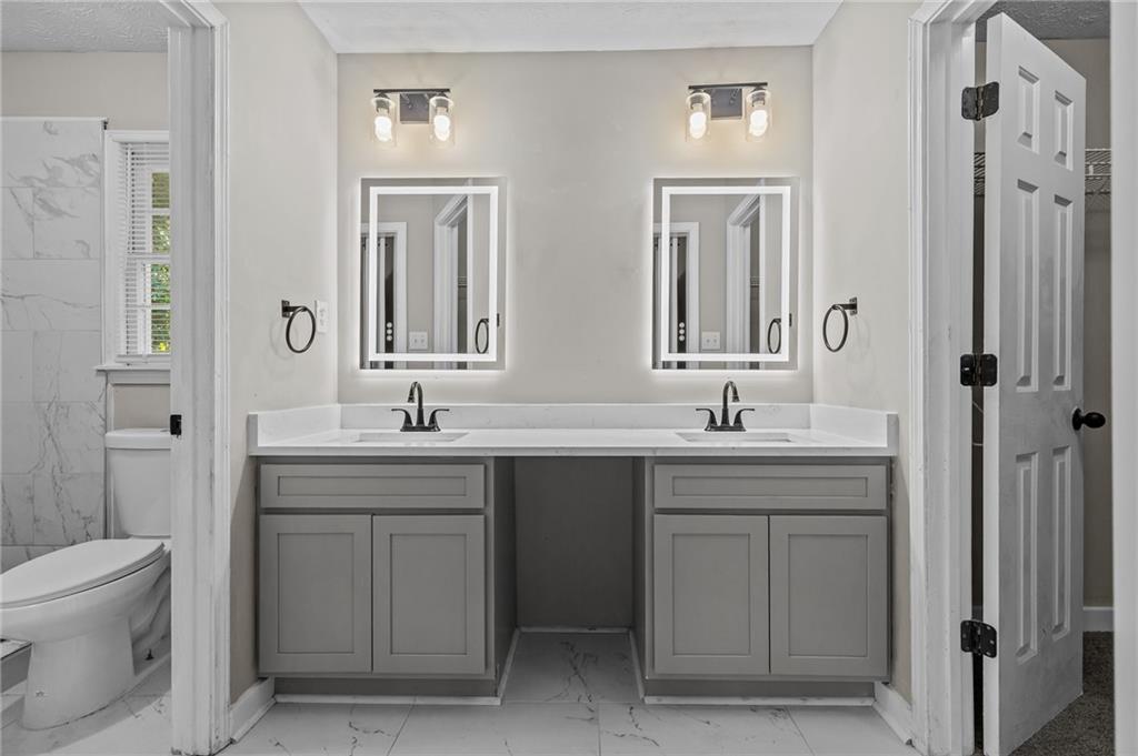 800 Post Rd Circle Stone Mountain, GA 30088 - Photo 31 of 45 a bathroom with a toilet sink and mirror