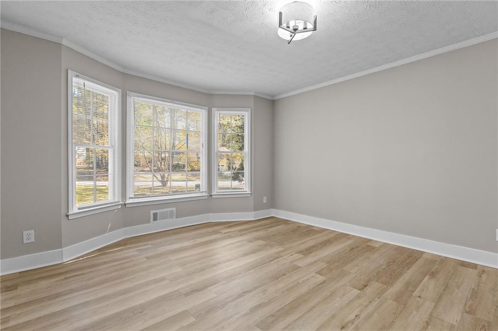 800 Post Rd Circle Stone Mountain, GA 30088 - Photo 8 of 45 a view of an empty room with wooden floor and a window