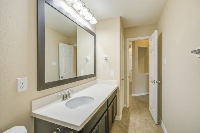 a bathroom with a sink a mirror and a shower