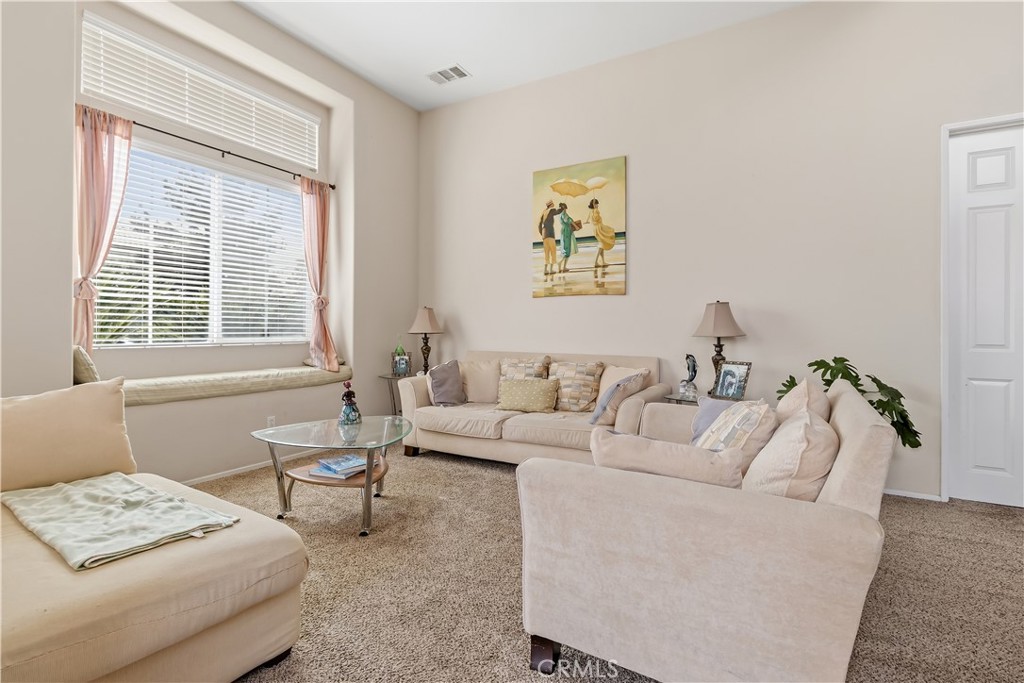 152 Alabaster Loop Perris, CA 92570 - Photo 5 of 29 a living room with furniture and a window