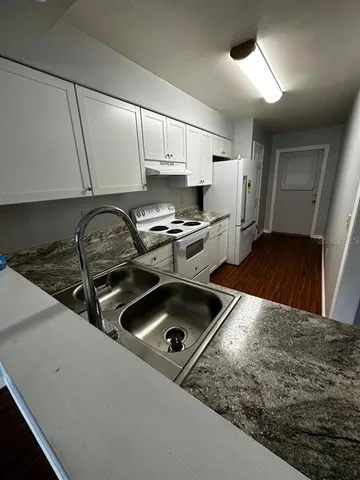 a kitchen with a stove a sink and a refrigerator