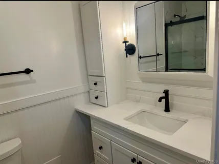 a bathroom with a sink and mirror
