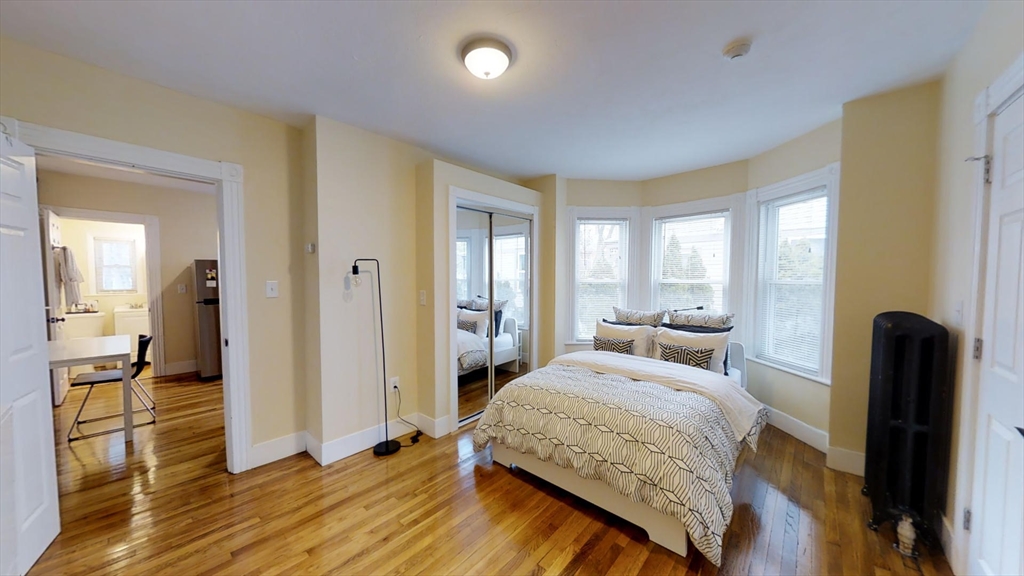 5 Blake Street, Unit 1 Cambridge, MA 02140 - Photo 1 of 41 a bedroom with a bed and wooden floor