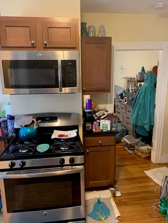 a kitchen with stainless steel appliances granite countertop a stove and a microwave