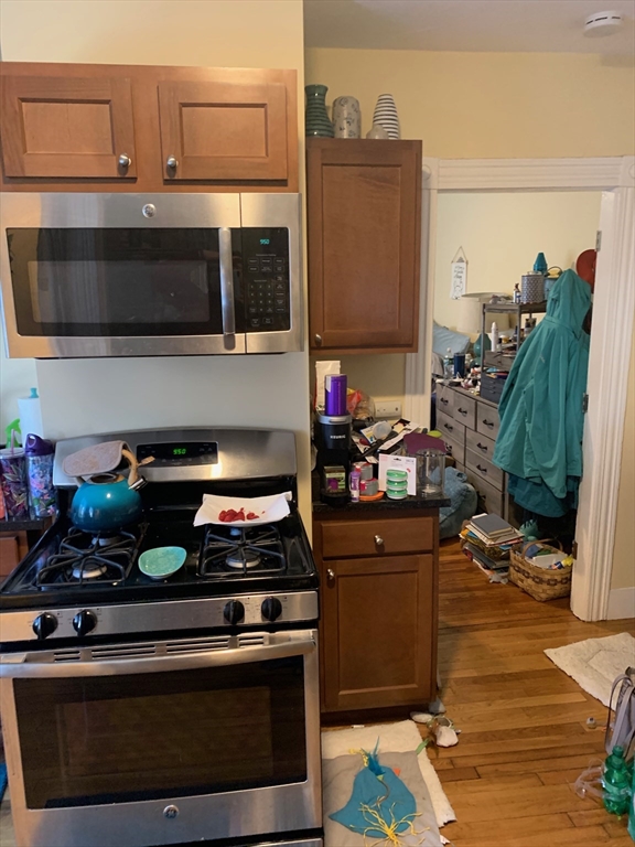 5 Blake Street, Unit 1 Cambridge, MA 02140 - Photo 18 of 41 a kitchen with stainless steel appliances granite countertop a stove and a microwave