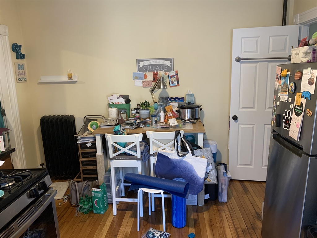 5 Blake Street, Unit 1 Cambridge, MA 02140 - Photo 22 of 41 a view of a workspace with furniture and wooden floor