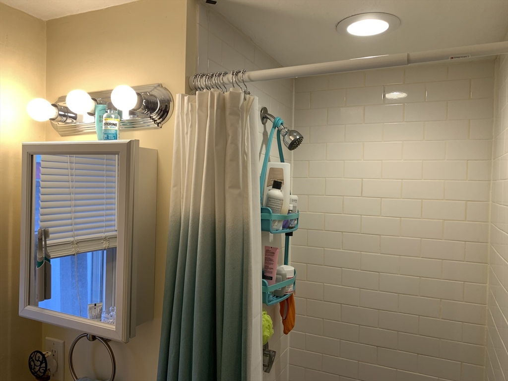 5 Blake Street, Unit 1 Cambridge, MA 02140 - Photo 28 of 41 a bathroom with a shower and a mirror