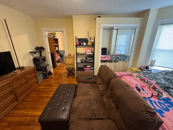 a bedroom with a bed and flat screen tv