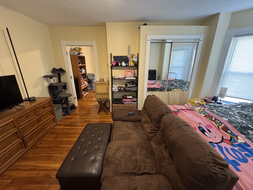 5 Blake Street, Unit 1 Cambridge, MA 02140 - Photo 31 of 41 a bedroom with a bed and wooden floor