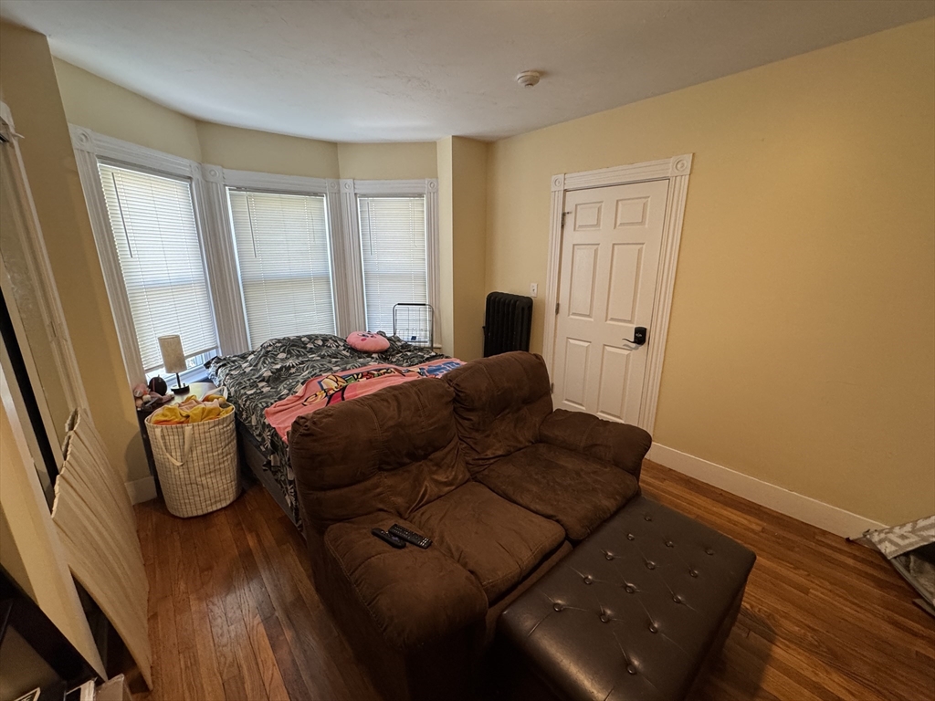 5 Blake Street, Unit 1 Cambridge, MA 02140 - Photo 32 of 41 a bedroom with a bed and wooden floor
