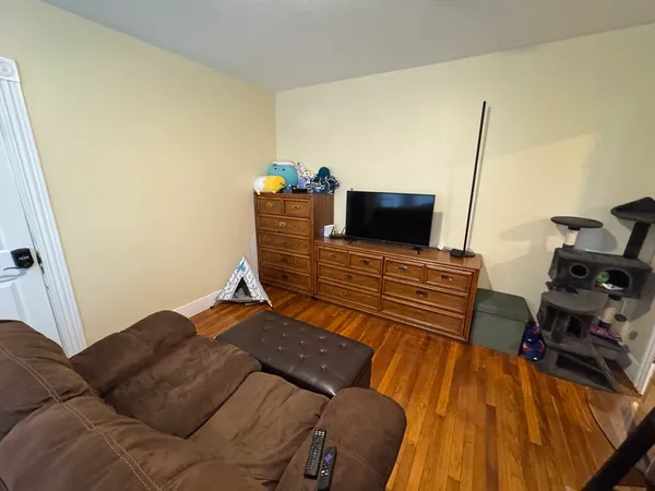a view of a living room with furniture and a flat screen tv