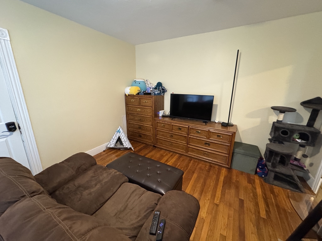 5 Blake Street, Unit 1 Cambridge, MA 02140 - Photo 33 of 41 a bedroom with a bed and flat screen tv