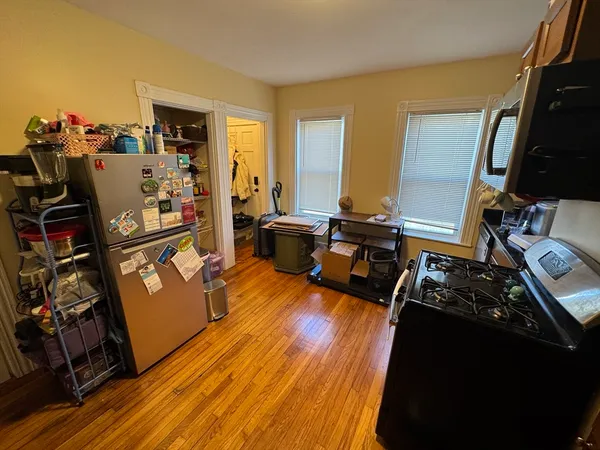a kitchen with granite countertop a stove and cabinets