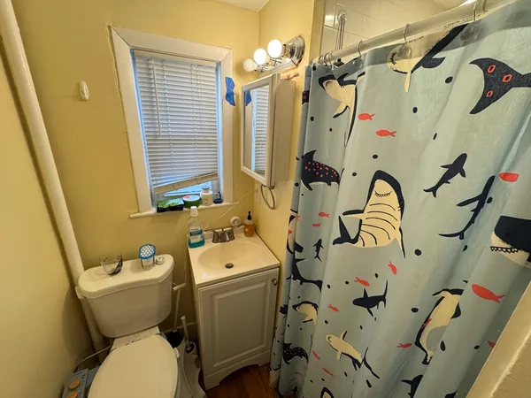 a bathroom with a sink and mirror with bathtub