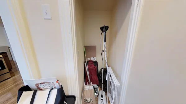 a view of a hallway with furniture and closet