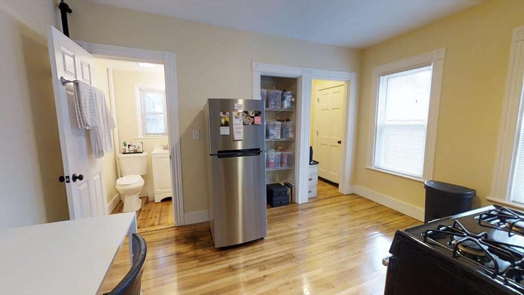 5 Blake Street, Unit 1 Cambridge, MA 02140 - Photo 7 of 41 a bedroom with a bed and wooden floor