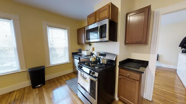 a kitchen with stainless steel appliances granite countertop a stove and a microwave