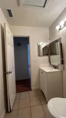 a bathroom with a sink a toilet and mirror