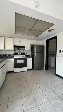 a kitchen with stainless steel appliances granite countertop a stove and a refrigerator