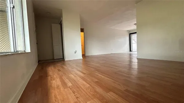 a view of an empty room and wooden floor