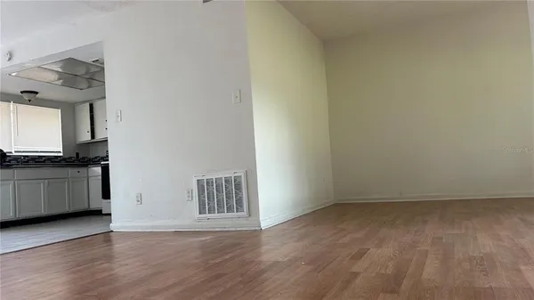 a view of a kitchen with an empty space and a window