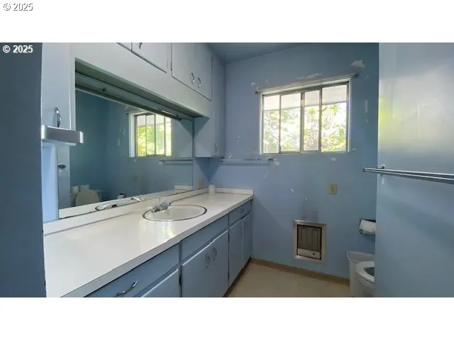 a bathroom with a sink vanity granite and a mirror