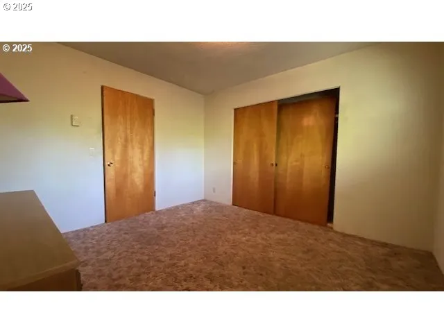 a black and white photo of a bedroom