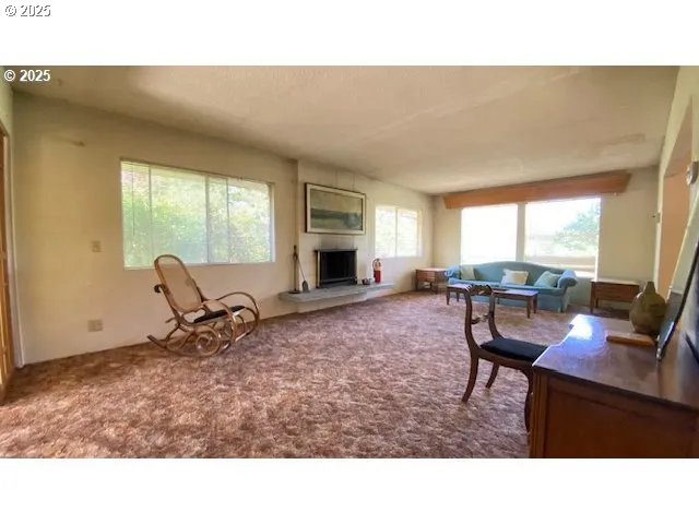 a living room with furniture a window and a flat screen tv