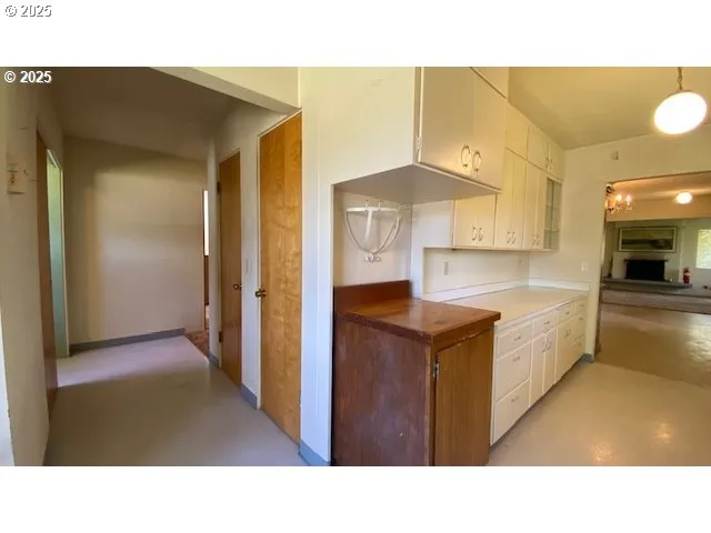 a open kitchen with stainless steel appliances kitchen island a chandelier