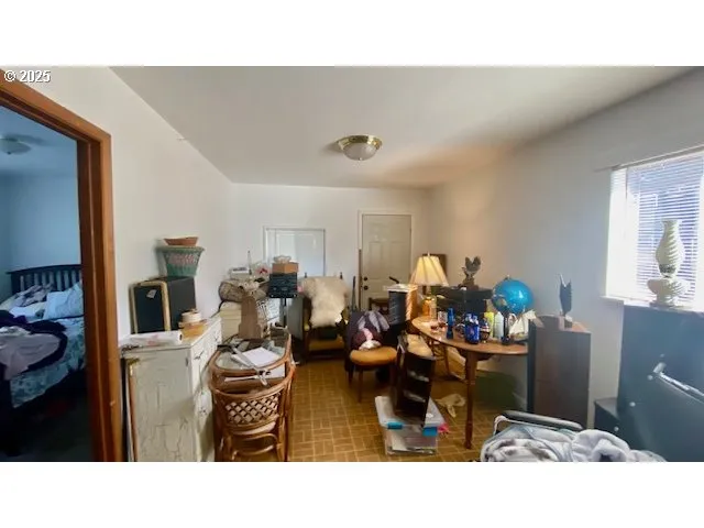 a living room with lots of furniture and clutter