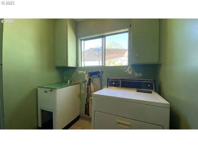 a kitchen with a sink cabinets and a window