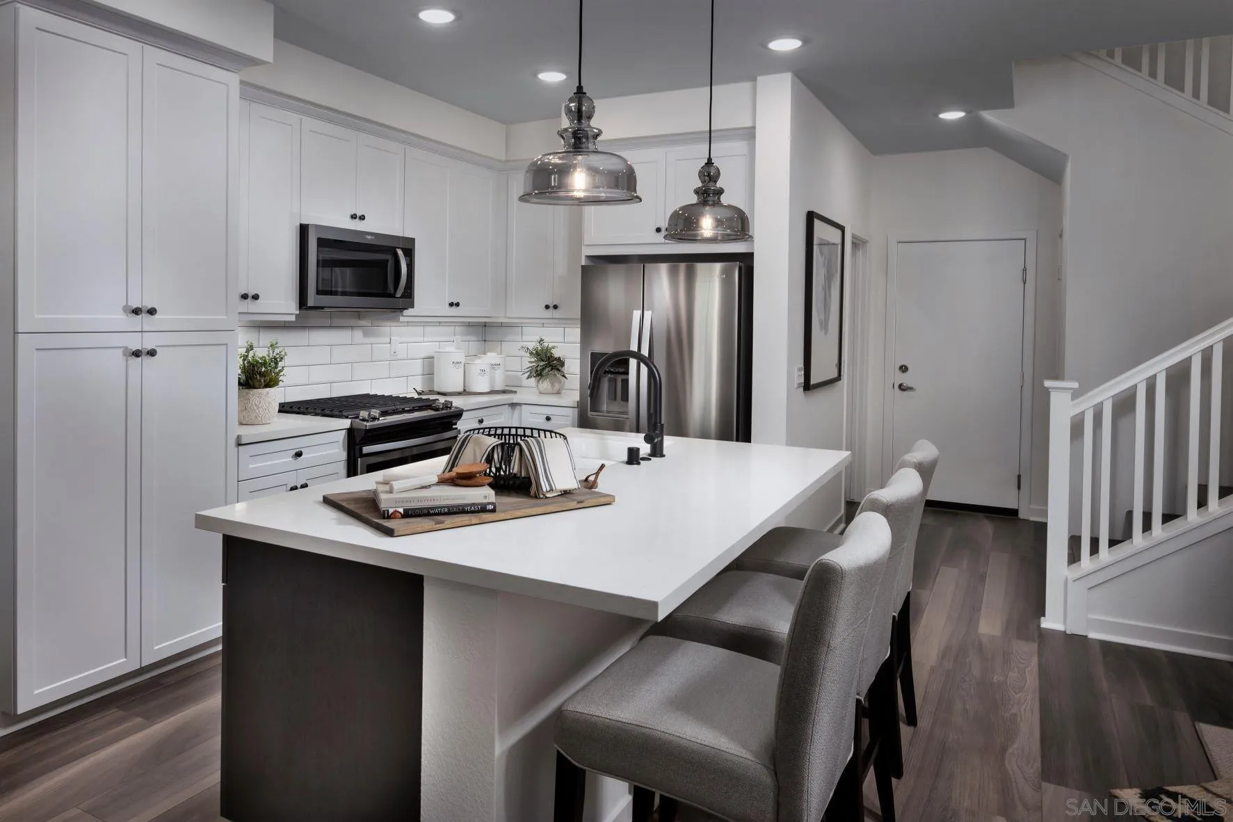 13084 Olympus Circle, Unit 3 Poway, CA 92064 - Photo 3 of 11 a kitchen with stainless steel appliances a dining table chairs microwave and view kitchen