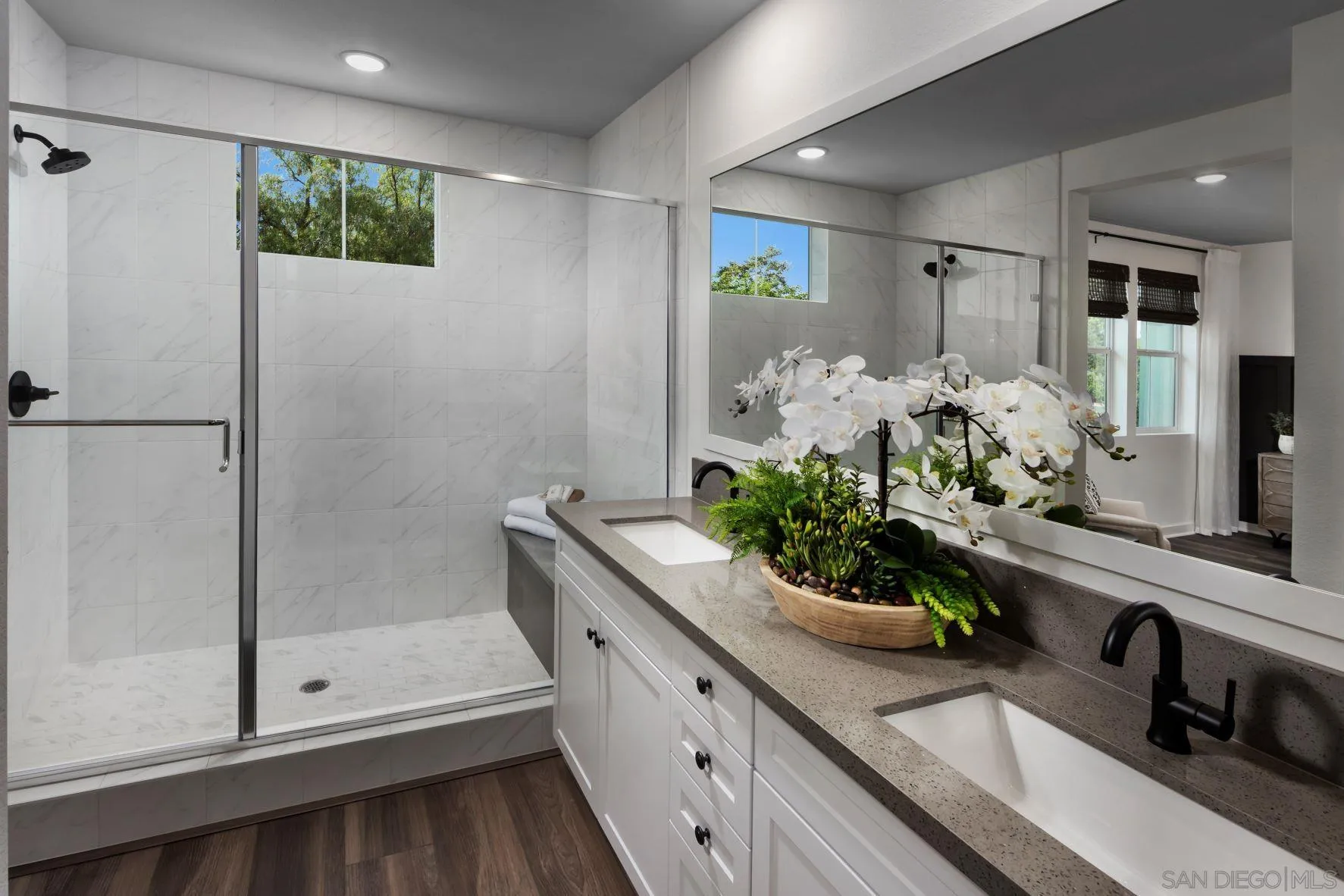 13084 Olympus Circle, Unit 3 Poway, CA 92064 - Photo 7 of 11 a bathroom with a double vanity sink and a mirror