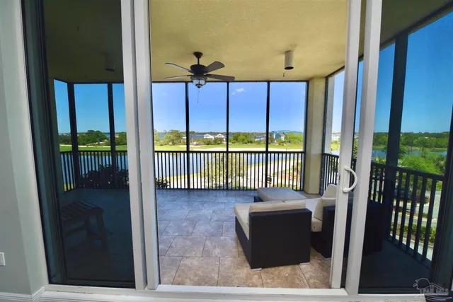 a kitchen with stainless steel appliances granite countertop wooden floor chairs sink and wooden cabinets