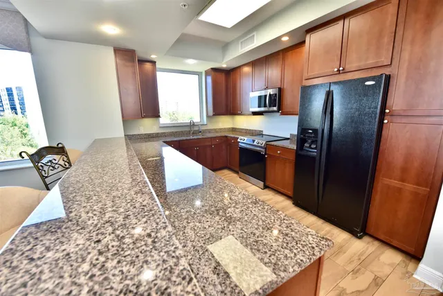 a living room with furniture a floor to ceiling window and a flat screen tv