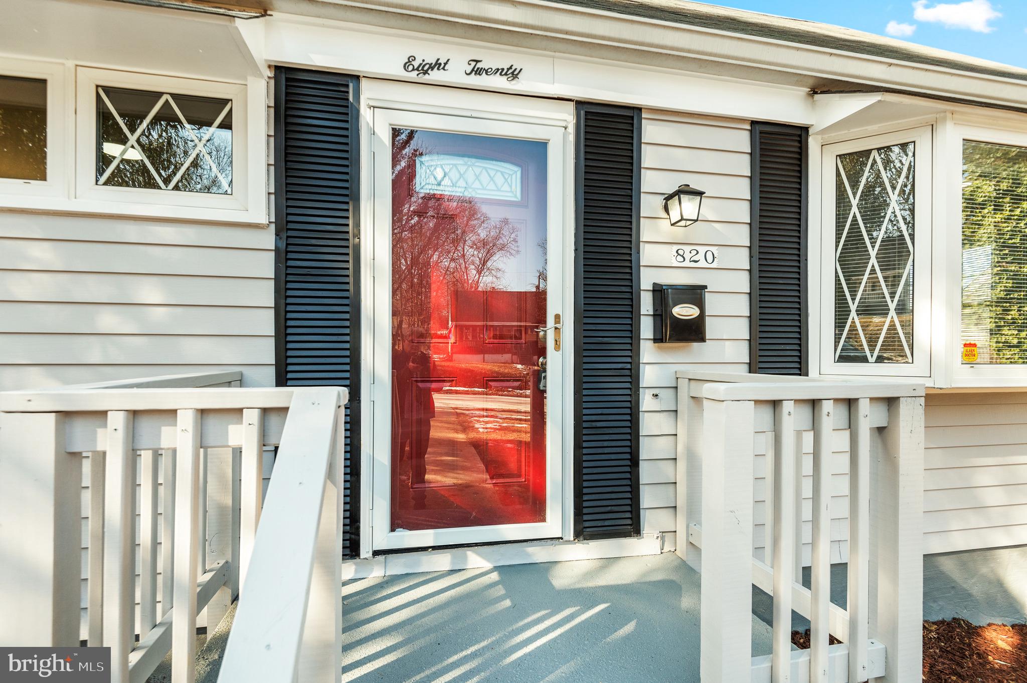 a view of front door of house with stairs