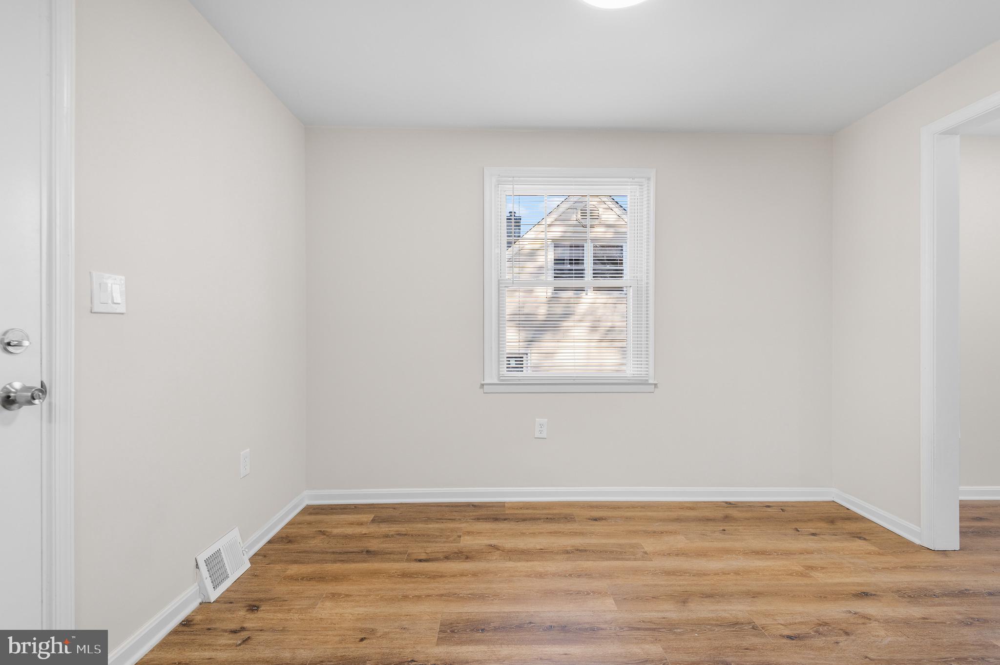 820 Templecliff Road Baltimore, MD 21208 - Photo 17 of 44 an empty room with wooden floor and windows
