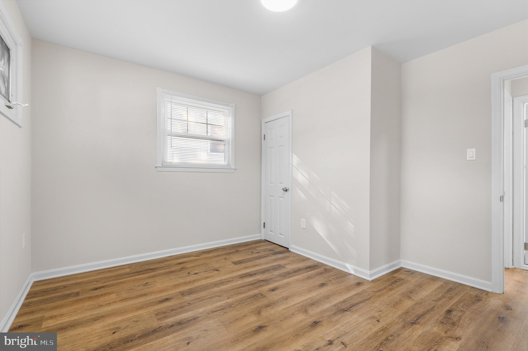 820 Templecliff Road Baltimore, MD 21208 - Photo 43 of 44 an empty room with wooden floor and windows
