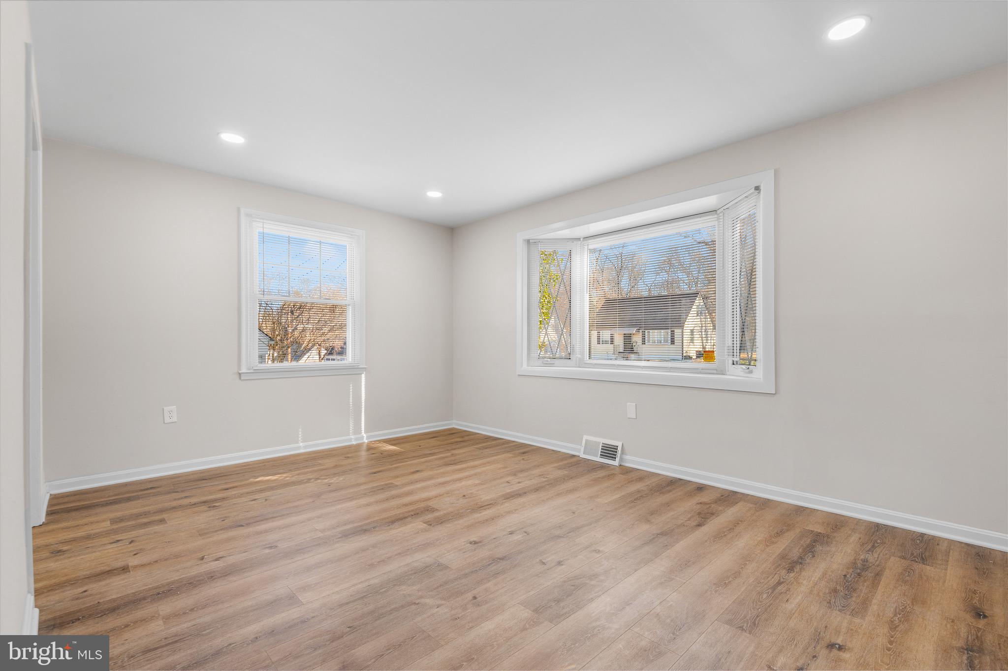 820 Templecliff Road Baltimore, MD 21208 - Photo 7 of 44 a view of an empty room with wooden floor and a window