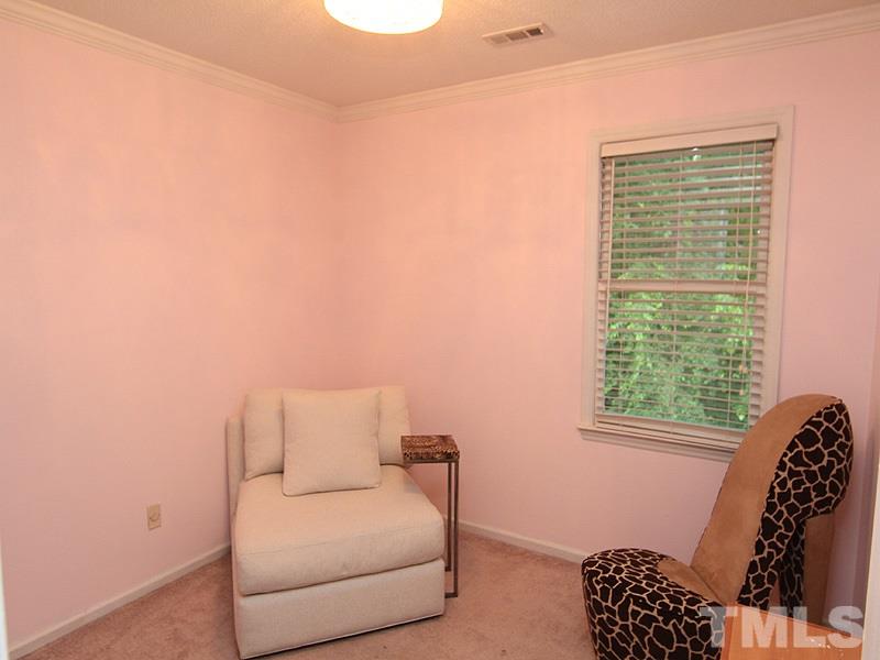 5584 Hamstead Crossing Raleigh, NC 27612 - Photo 12 of 17 a bedroom with a bed and a chair