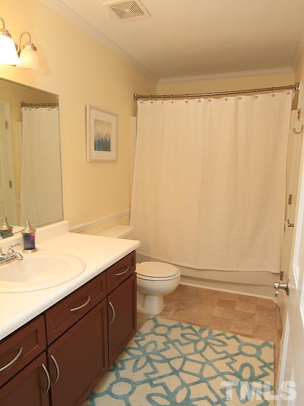 5584 Hamstead Crossing Raleigh, NC 27612 - Photo 14 of 17 a bathroom with a sink a toilet and shower