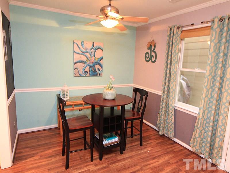 5584 Hamstead Crossing Raleigh, NC 27612 - Photo 5 of 17 a view of a dining room with furniture window and wooden floor