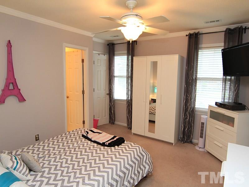5584 Hamstead Crossing Raleigh, NC 27612 - Photo 9 of 17 a bedroom with a bed and a flat screen tv