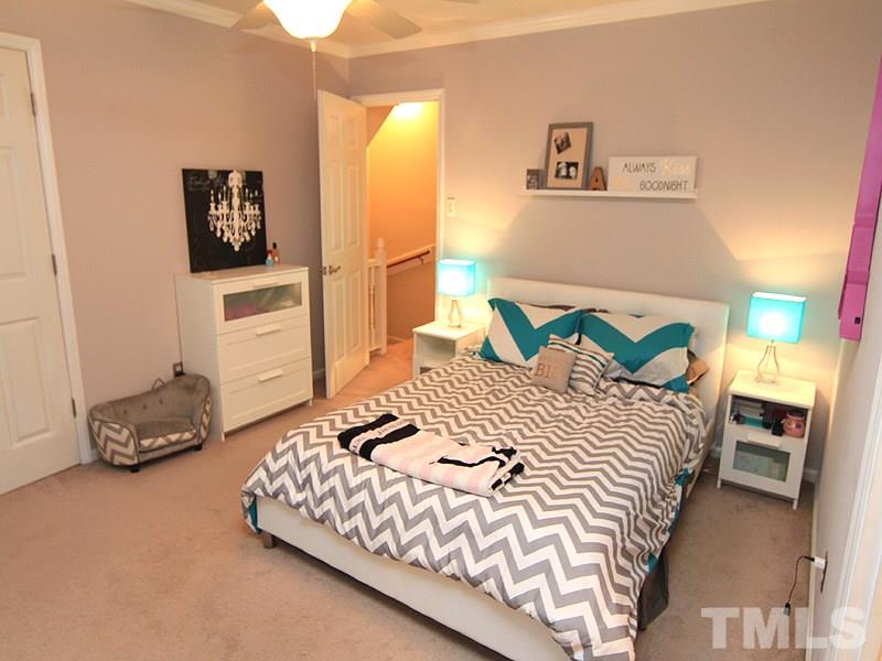 5584 Hamstead Crossing Raleigh, NC 27612 - Photo 10 of 17 a bedroom with a bed and a lamp with window