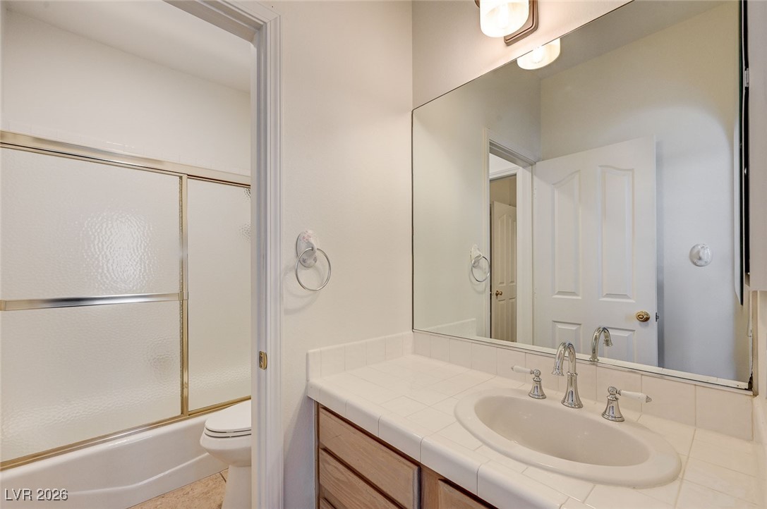 2955 El Camino Road Las Vegas, NV 89146 - Photo 47 of 99 Full bathroom featuring vanity and bath / shower combo with glass door