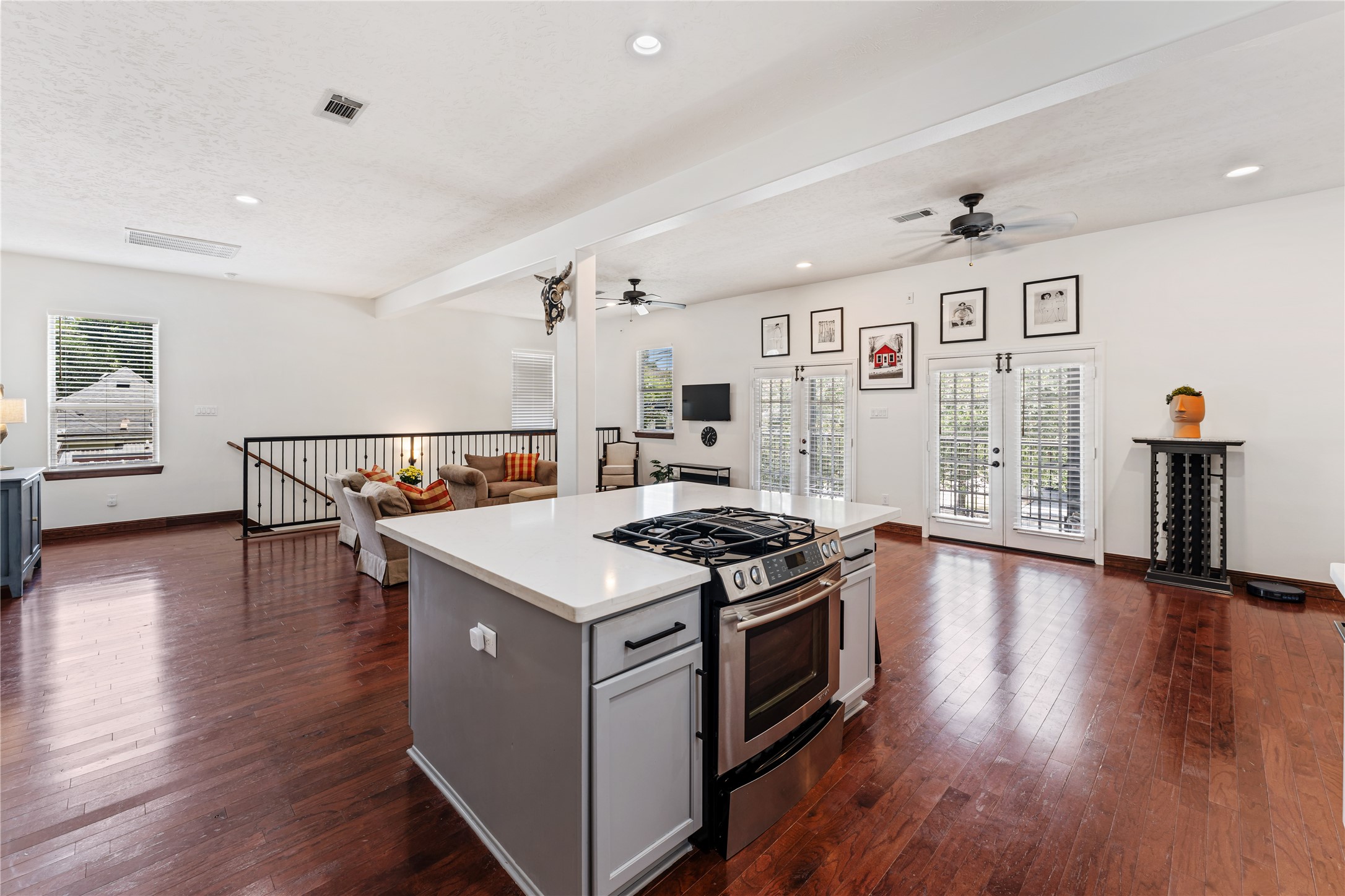 415 West 8th Street Houston, TX 77007 - Photo 29 of 39 The open layout allows the kitchen to flow naturally into the living area, creating an ideal setting for entertaining. French doors invite in natural light while providing easy access to the covered balcony, blending indoor comfort with outdoor living.