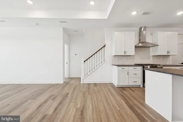 a view of kitchen with wooden floor and electronic appliances