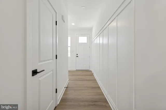 a view of a hallway with wooden floor