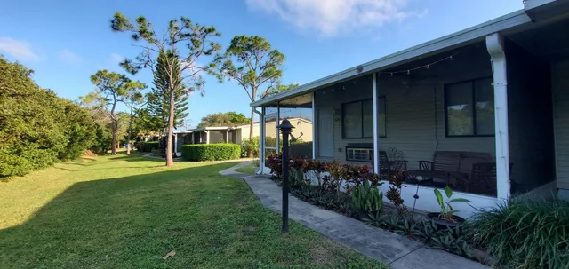 a view of a house with backyard porch and garden
