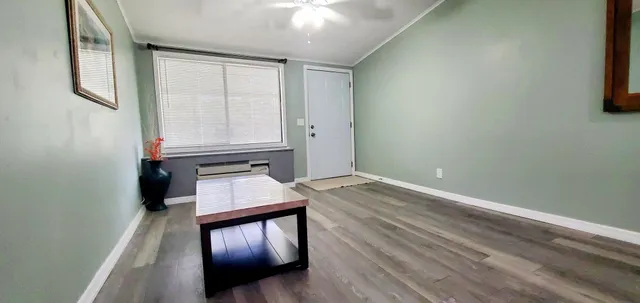 a view of an empty room and wooden floor